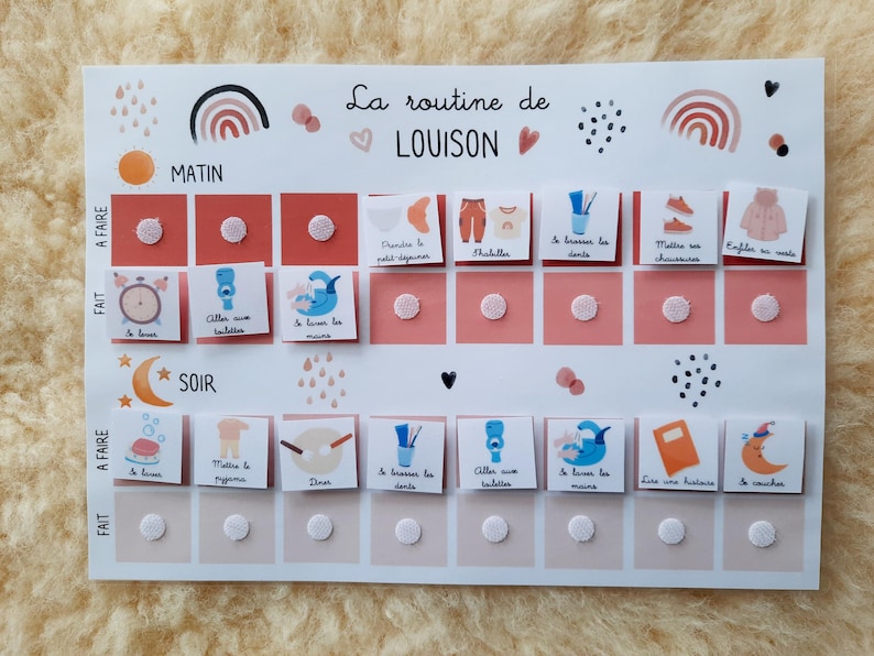 May include: A white printable chart with a pink and peach color scheme. The chart is titled "La routine de LOUISON" and has a daily routine for a child. The chart includes activities like getting dressed, brushing teeth, and reading a story.