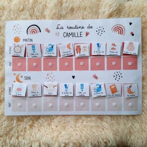 May include: A pink and white chart with the words "La routine de Camille" at the top. The chart is divided into two sections, "Matin" and "Soir". Each section has a list of activities with corresponding illustrations. The activities include "Se lever", "Aller aux toilettes", "Se laver les mains", "Prendre le petit-dejeuner", "S'habiller", "Se brosser les dents", "Mettre ses chaussures", "Enfiler sa veste", "Mettre la pyjama", "Diner", "Se laver les mains", "Lire une histoire", "Se coucher".