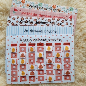 Pode incluir: Um conjunto de gráficos decorativos coloridos com o texto "Je deviens propre" e nomes como "Mattia" e "Mathilde". Os gráficos apresentam padrões de corações e flores, com uma grade para rastrear o progresso usando adesivos emoji.