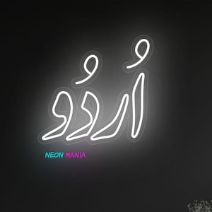 May include: White neon sign with the Arabic word "أروى" in a cursive script. The sign is mounted on a black wall above a gray couch in a living room.