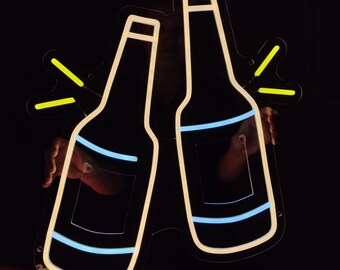 May include: Neon sign depicting two white outline beer bottles with blue liquid and yellow highlights, clinking together in a celebratory toast.