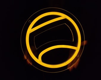 May include: A yellow neon sign in the shape of a tennis ball. The sign is lit up and is on a black background.