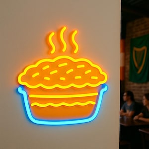 May include: A neon sign in the shape of a pie, with a blue outline on the bottom and a yellow and orange pie filling. The sign is mounted on a white wall. The pie has steam rising from it.