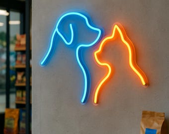 May include: A blue neon outline of a dog's head and a orange neon outline of a cat's head on a gray wall.