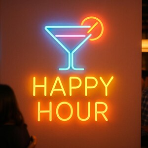 May include: A neon sign with a cocktail glass and a lemon slice, in blue, pink, and orange. The words "HAPPY HOUR" are in bright yellow. The sign is mounted on a peach-colored wall.