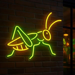 May include: A neon green and yellow grasshopper silhouette on a brick wall. The neon sign is lit up and glowing.