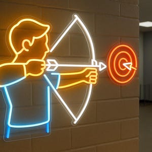 May include: A neon sign depicting an archer aiming at a target. The archer is outlined in yellow and blue, with a white bow and arrow. The target is orange with a white bullseye. The sign is mounted on a brick wall.