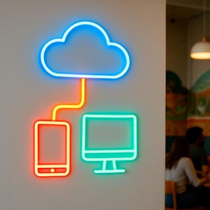 May include: A neon sign depicting a cloud, smartphone, and computer, connected by lines. The cloud is outlined in blue, the smartphone in red, and the computer in green. The connecting lines are orange. The sign is mounted on a light gray wall.