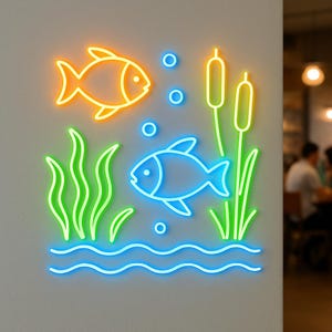 May include: A neon wall sign featuring an orange fish at the top left and a blue fish in the center. The design includes green aquatic plants, yellow cattails, blue bubbles, and wavy blue lines at the bottom, all illuminated against a wall.