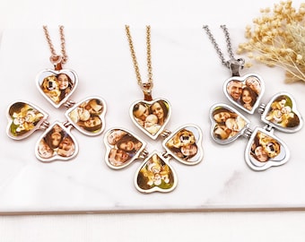 May include: Three gold, rose gold, and silver necklaces with four heart-shaped photo locket pendants. Each locket has a different photo of a family with a dog.