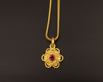 Greek gold pendant with ruby gemstone