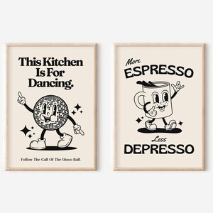 May include: Two framed art prints with retro-style illustrations. One features a disco ball character with the text "This Kitchen Is For Dancing." The other shows a coffee cup with the text "More Espresso Less Depresso."