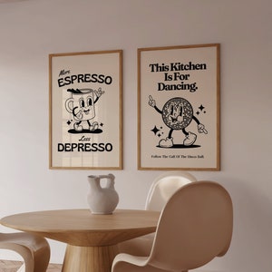 May include: Two framed art prints with a retro design. One says "More ESPRESSO Less DEPRESSO" with a cartoon coffee cup. The other says "This Kitchen Is For Dancing" with a disco ball character. Both are in wooden frames.