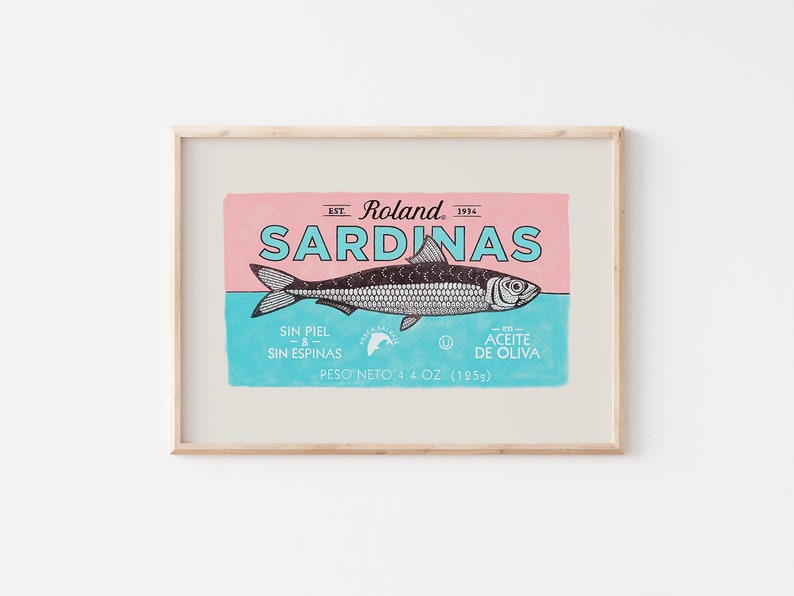 May include: A vintage-style illustration of a sardine can label. The label is pink and blue with black text and a black and white illustration of a sardine. The text reads "Est. Roland 1914 Sardinas Sin Piel & Sin Espinas En Aceite De Oliva Peso Neto 4.4 Oz. (125g)"