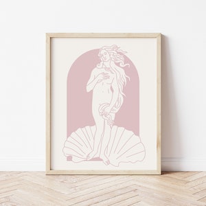 Peut inclure: Une impression encadr&eacute;e d'un dessin au trait de la Naissance de V&eacute;nus, un c&eacute;l&egrave;bre tableau de la Renaissance. La figure est repr&eacute;sent&eacute;e dans un sch&eacute;ma de couleurs rose et blanc.