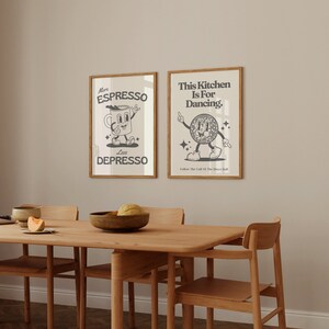 May include: Two framed art prints with a retro design. One says "More Espresso Less Depresso" with a coffee cup character. The other says "This Kitchen Is For Dancing" with a disco ball character. Both are in wooden frames.