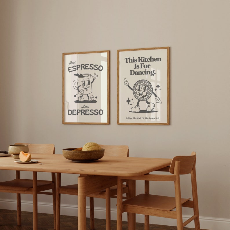 May include: Two framed art prints with a retro design. One says "More Espresso Less Depresso" with a coffee cup character. The other says "This Kitchen Is For Dancing" with a disco ball character. Both are in wooden frames.