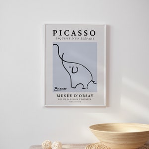 May include: A framed print of a black and white line drawing of an elephant by Pablo Picasso. The print is titled "Esquisse d'un &Eacute;l&eacute;phant" and includes the artist's signature and the name of the museum where the original artwork is located, Mus&eacute;e d'Orsay in Paris, France.