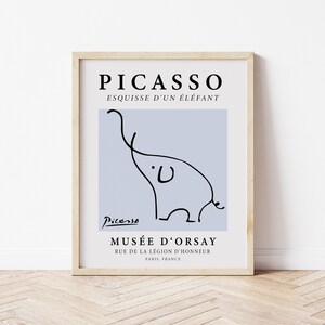 May include: A framed print of a black and white line drawing of an elephant by Pablo Picasso. The print is on a light blue background and includes the text "PICASSO", "ESQUISSE D'UN &Eacute;L&Eacute;FANT", "Picasso", "MUS&Eacute;E D'ORSAY", "RUE DE LA L&Eacute;GION D'HONNEUR", and "PARIS, FRANCE".