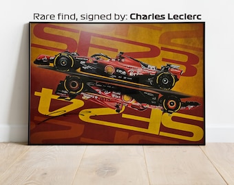 May include: A red and yellow poster featuring a Formula 1 race car with the number 55 on the side. The car is reflected in the background, and the words "SF23" are repeated in a bold, graphic font. The poster is signed by Charles Leclerc.