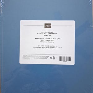 May include: A pack of 24 sheets of Pacific Point blue cardstock, wrapped in clear plastic. The label states the size is 8-1/2 inches by 11 inches, made in the USA, and includes a barcode with the product number 111350 and Stampin' Up branding.