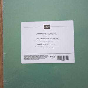 May include: A pack of 24 sheets of Just Jade cardstock measuring 8-1/2 inches by 11 inches, wrapped in clear plastic. The white label features the Stampin' Up! logo, product name, and specifications including acid-free and lignin-free details.