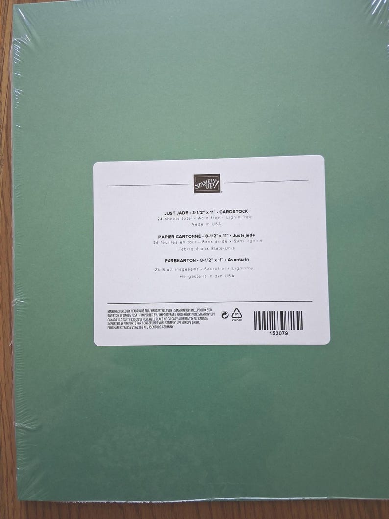 May include: A pack of 24 sheets of Just Jade cardstock measuring 8-1/2 inches by 11 inches, wrapped in clear plastic. The white label features the Stampin' Up! logo, product name, and specifications including acid-free and lignin-free details.