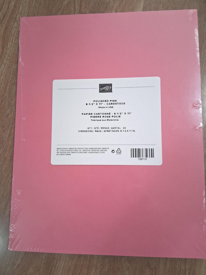 May include: A pack of 24 sheets of Polished Pink cardstock measuring 8-1/2 inches by 11 inches. The package is wrapped in clear plastic and features a white label with the Stampin' Up! logo, product name, and manufacturing information.