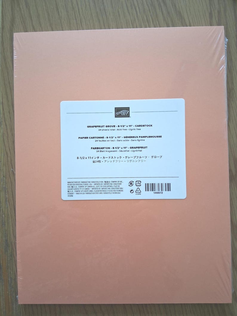 May include: A pack of 24 sheets of Grapefruit Grove cardstock measuring 8-1/2 inches by 11 inches. The paper is wrapped in clear plastic and features a white label with the Stampin' Up! logo, product name, and manufacturing details.