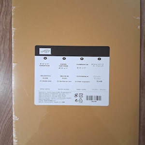 May include: A pack of 24 sheets of 8-1/2 inch by 11 inch Delightful Dijon cardstock by Stampin' Up. The package is wrapped in clear plastic and features a white label with product details, including the color name and sheet count.