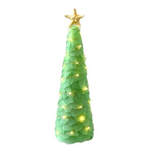 May include: A decorative green Christmas tree with a gold starfish topper. The tree is adorned with small, warm white lights. The tree is made of a soft, leaf-like material.