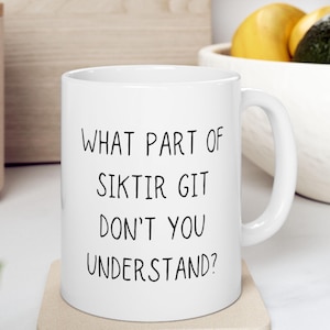 May include: White ceramic coffee mug with black text that reads "What part of siktir git don't you understand?"