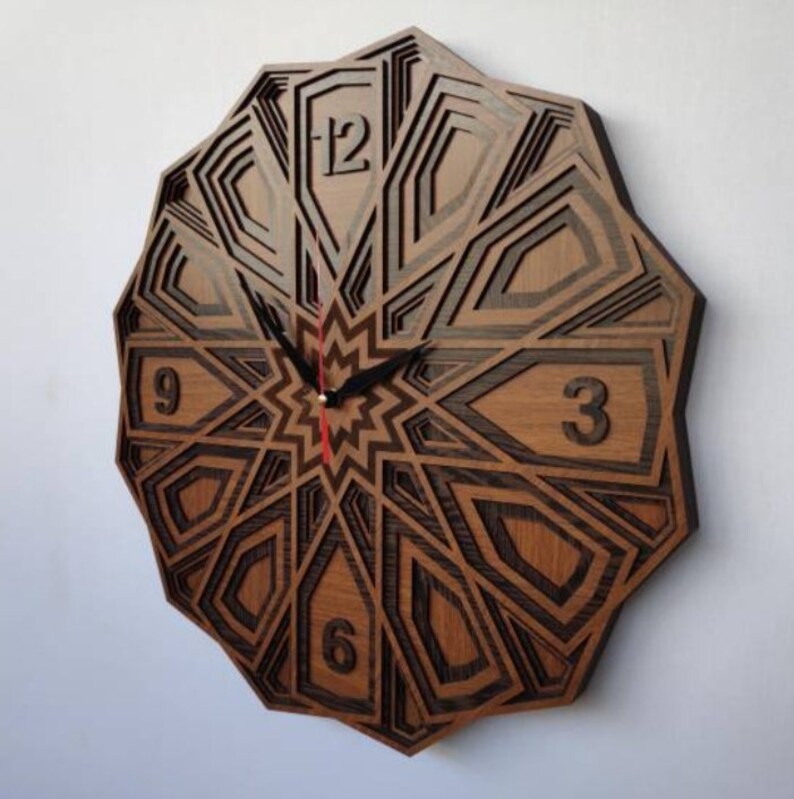 May include: A wooden wall clock with a geometric design. The clock face features Roman numerals and black hands. The clock is made of dark wood with a light wood inlay.