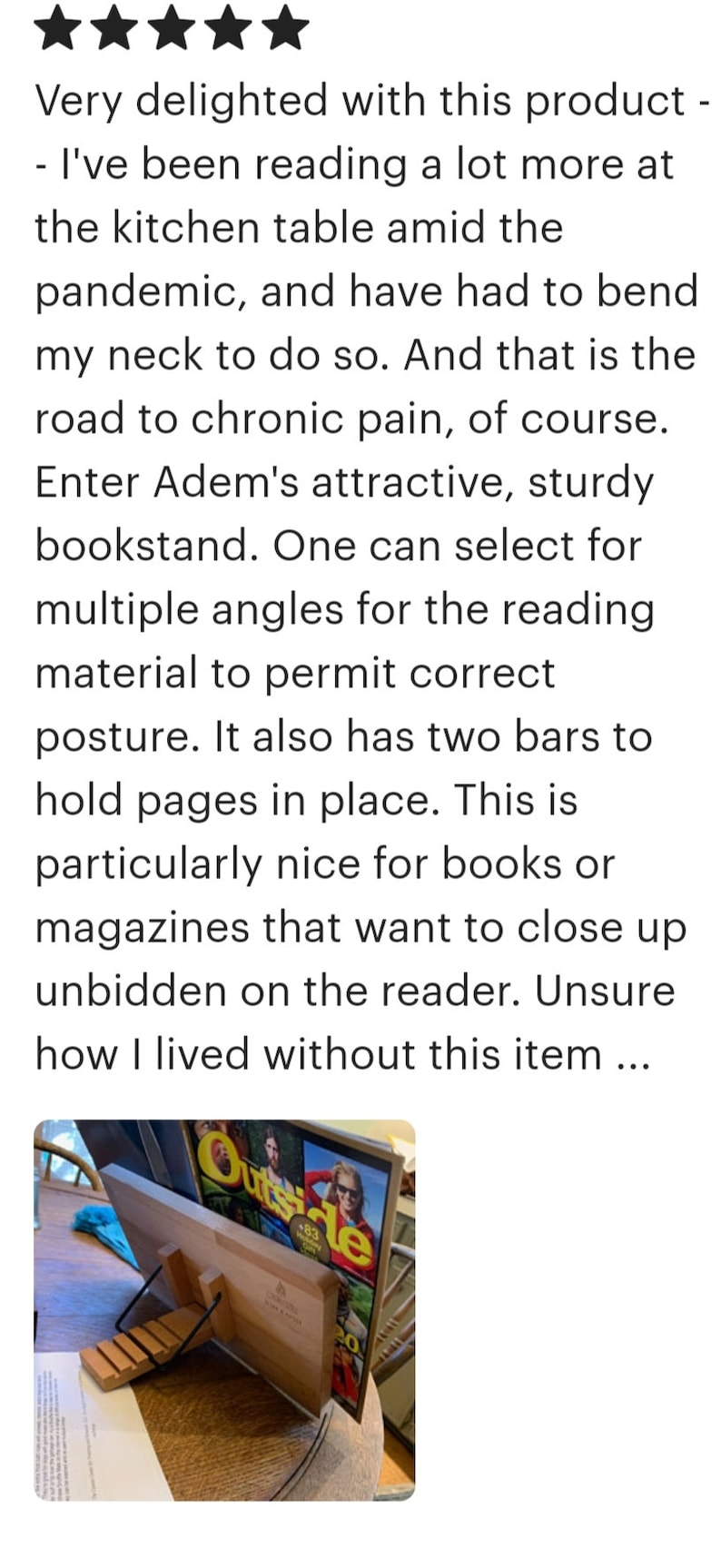 Pode incluir: Um suporte de livros de madeira com duas barras de metal para segurar as p&aacute;ginas no lugar. O suporte de livros &eacute; feito de madeira natural e tem um design simples e elegante. O suporte de livros est&aacute; segurando uma revista intitulada "Outside" com uma foto de uma mulher usando &oacute;culos de sol na capa.