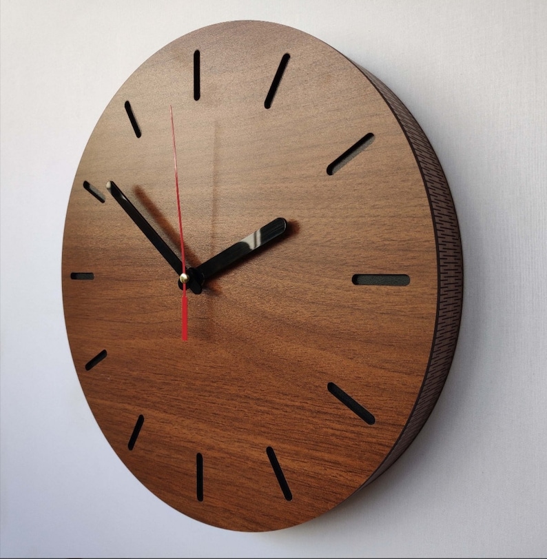 May include: A brown wooden wall clock with black hour markers and black hands. The clock has a red second hand.
