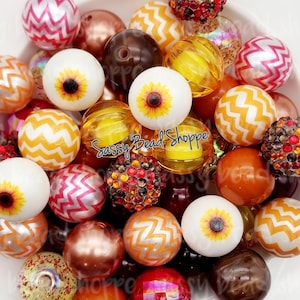 May include: A collection of colorful beads in various shapes and sizes, including sunflower designs, chevron patterns, and sparkly accents. The beads are perfect for crafting jewelry or other DIY projects.