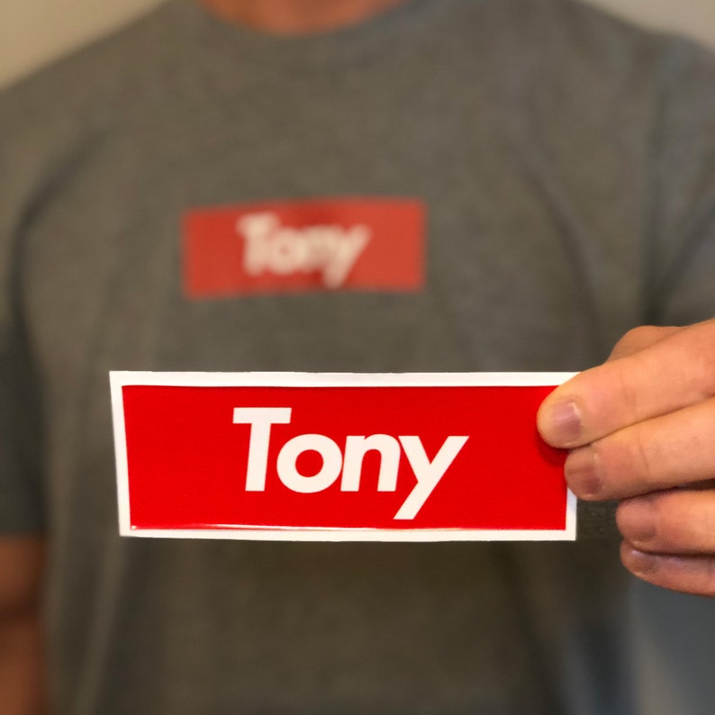 May include: A red rectangular sticker with white border and the word "Tony" in white letters.