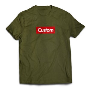May include: A green t-shirt with a red box that says "Custom" in white letters.