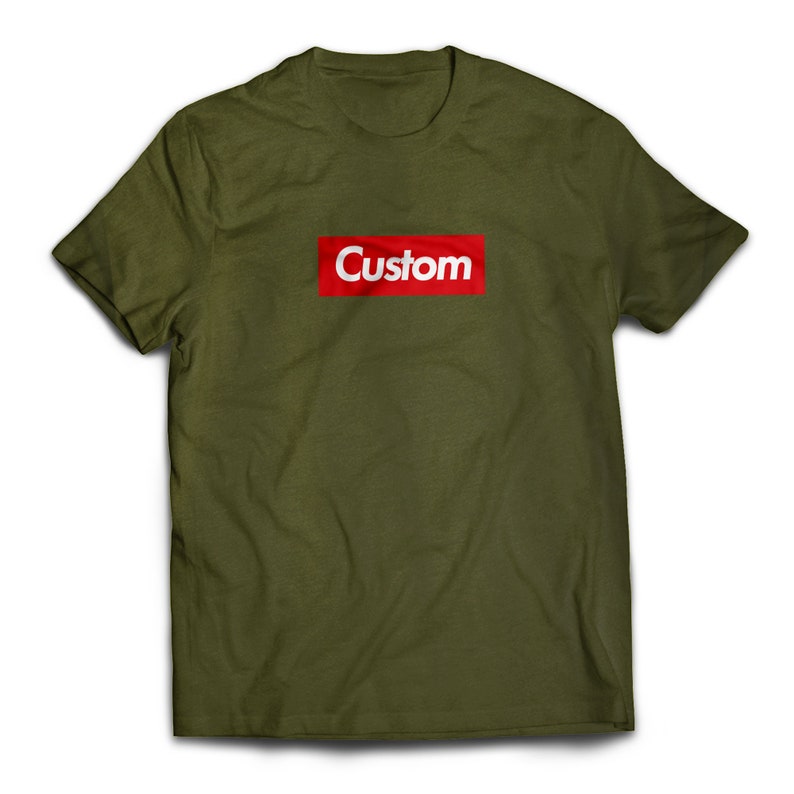 May include: A green t-shirt with a red box that says "Custom" in white letters.
