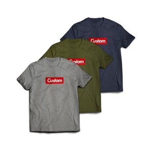 May include: Three t-shirts with the word "Custom" printed in a red box on the front. The shirts are in gray, green, and blue.