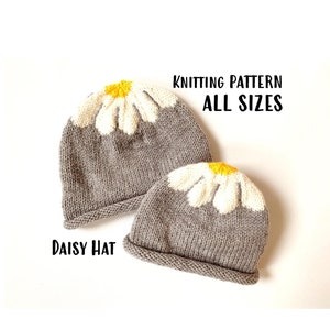 May include: Knitting pattern for a daisy hat in all sizes. The pattern features two gray hats with white daisy flowers and yellow centers.