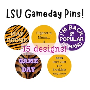 May include: Five circular pins featuring various designs and text including LSU Gameday Pins!, PLAY BOOSIE, Cigarette Mmm... :), I'M BACK BY POPULAR DEMAND, 15 designs!, GAME DAY, and BEER Isn't Just For Breakfast Anymore in orange, black, purple, and yellow.