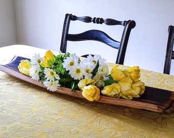 May include: A wooden serving tray made from a reclaimed wine barrel, featuring a rustic, natural finish. The tray is filled with a bouquet of white and yellow flowers, including daisies and tulips.