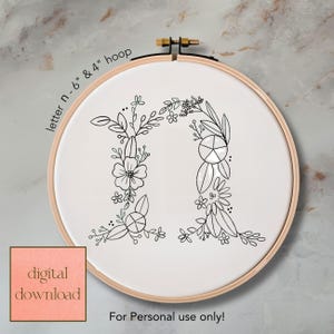 May include: A digital download of an embroidery design featuring the letter "N" decorated with floral elements. The design is displayed in a 6-inch and 4-inch hoop. The text "For Personal use only!" is included.