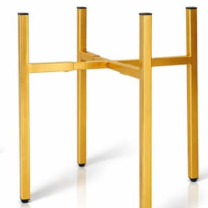 May include: A gold-colored metal plant stand with a cross-shaped base and four vertical legs. The legs have black caps on the bottom. The stand is designed to hold a plant pot.