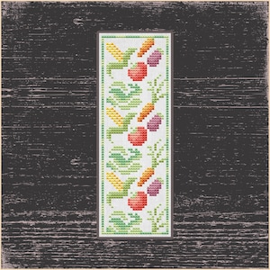 May include: A white bookmark with a repeating pattern of green leaves, orange carrots, and red tomatoes. The bookmark is embroidered with colorful thread.