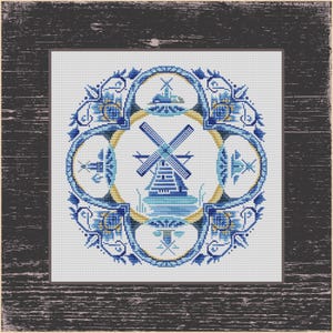 May include: A cross-stitch design featuring a blue and white windmill scene, surrounded by floral and geometric patterns. The design is framed in a dark wood-look border, evoking a vintage aesthetic. The windmill is set against a water background.