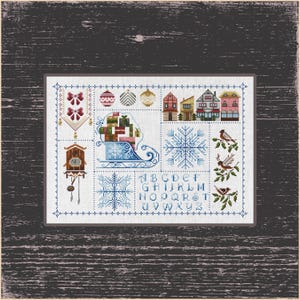 May include: Cross-stitch sampler with a festive Christmas theme. The design features a sleigh with gifts, snowflakes, houses, birds, and a cuckoo clock. The sampler is framed and uses blue, red, green, and brown colours.