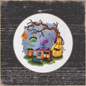 May include: A cross-stitch design featuring Halloween elements. A jack-o'-lantern with headphones, a witch's hat, a radio, a Venus flytrap, and a flame are arranged under a tree with string lights. The design is set in a circular frame.