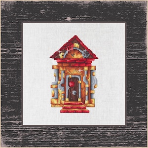 May include: Cross-stitch art of a whimsical steampunk house. The house features a red roof, brick walls, and metallic accents. A heart-shaped detail adorns the door. The artwork is framed in a rustic, dark wood frame.